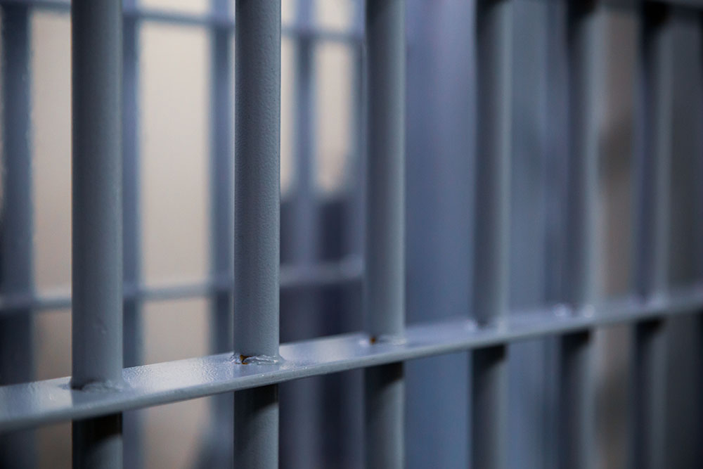 Promo image for the Jail Records section of the website. Image of modern prison jail bars.