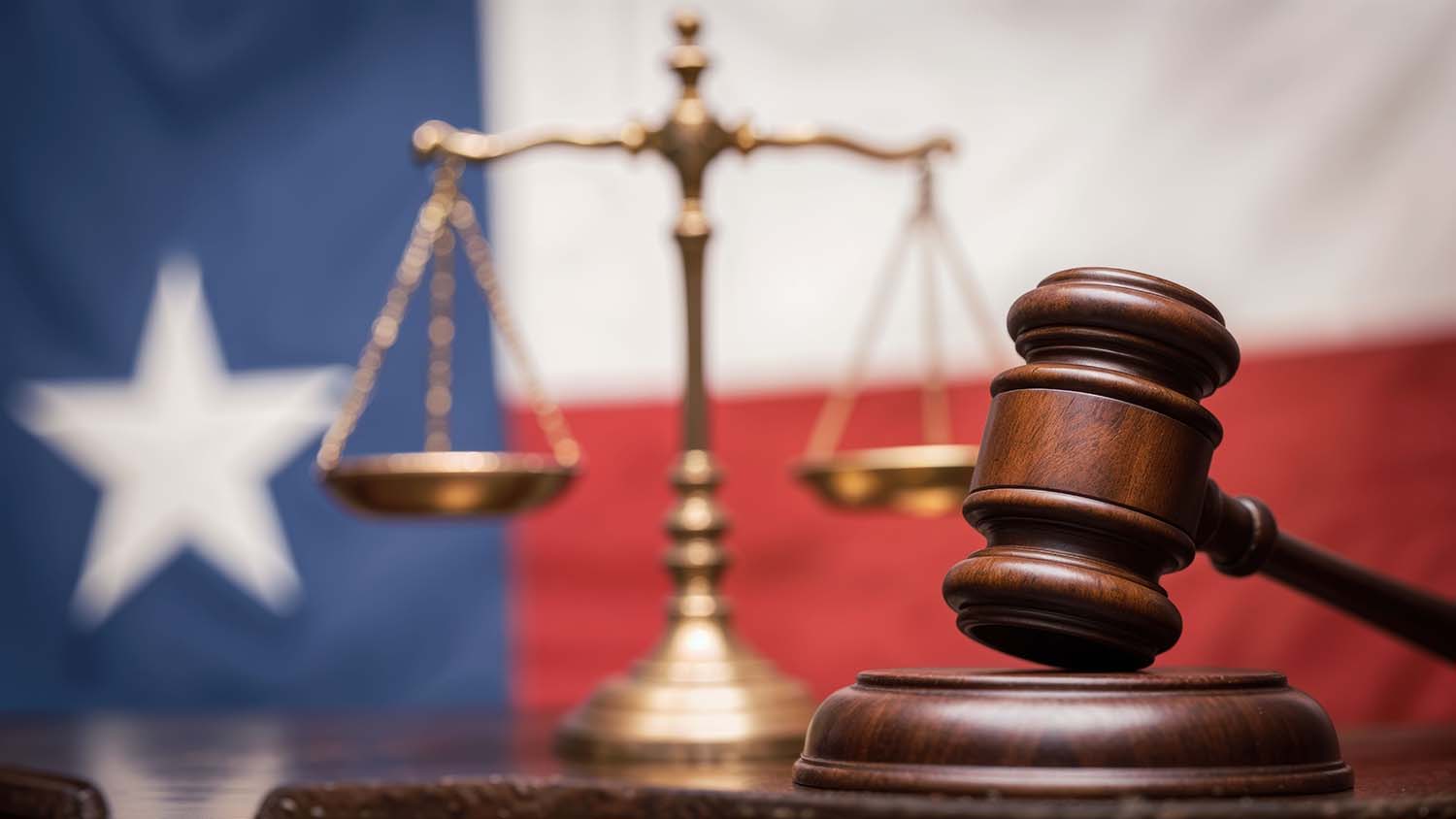 legal gavel with scales of justice and texas flag