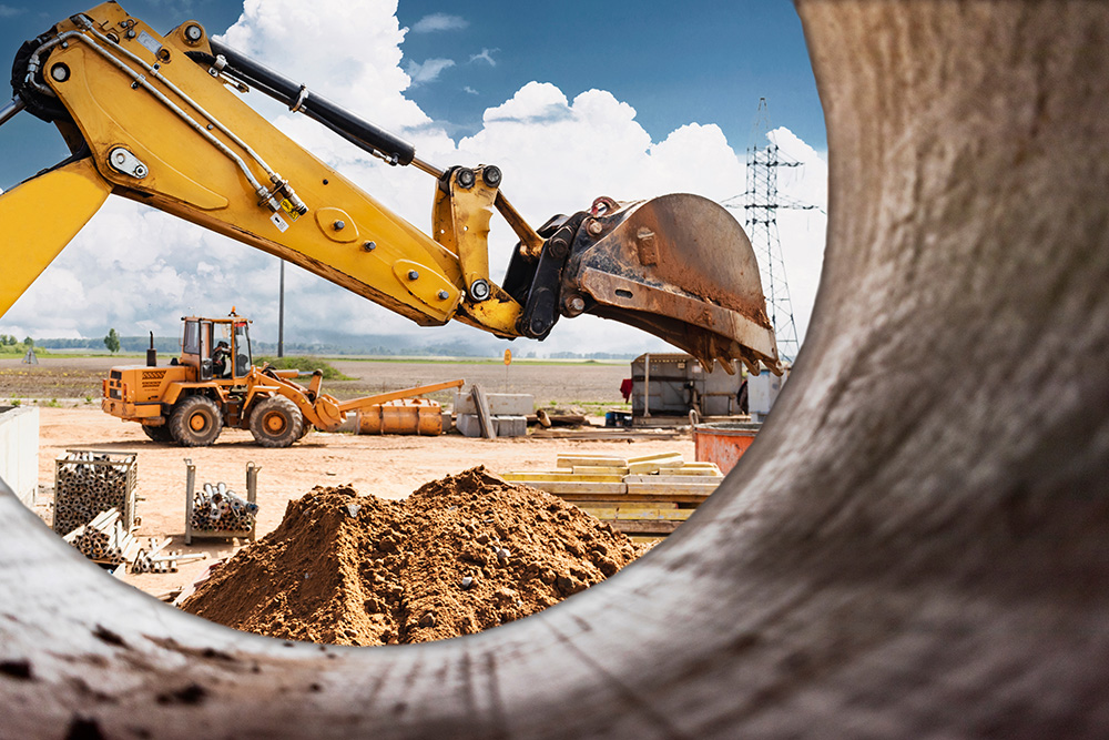 a backhoe moves dirt on a construction site.