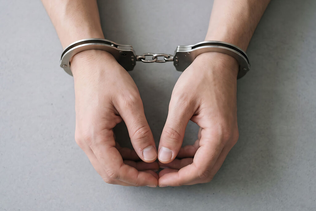 An image of hands with handcuffs on them.