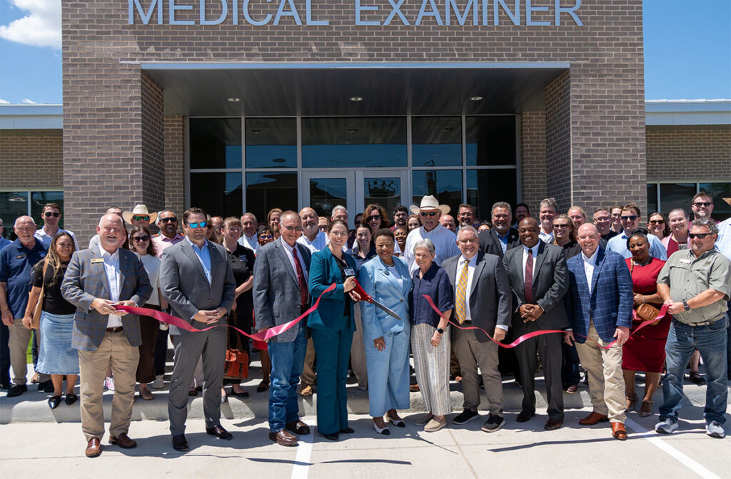 Group photo of the ribbon cutting at the Medical Examiner's office on August 18, 2026.